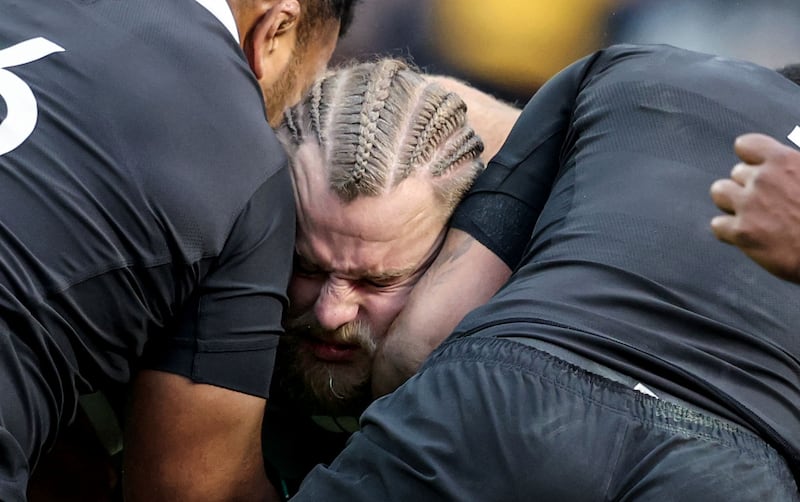 Ireland prop Finlay Bealham is tackled by All Blacks players. Photograph: Dan Sheridan/INPHO