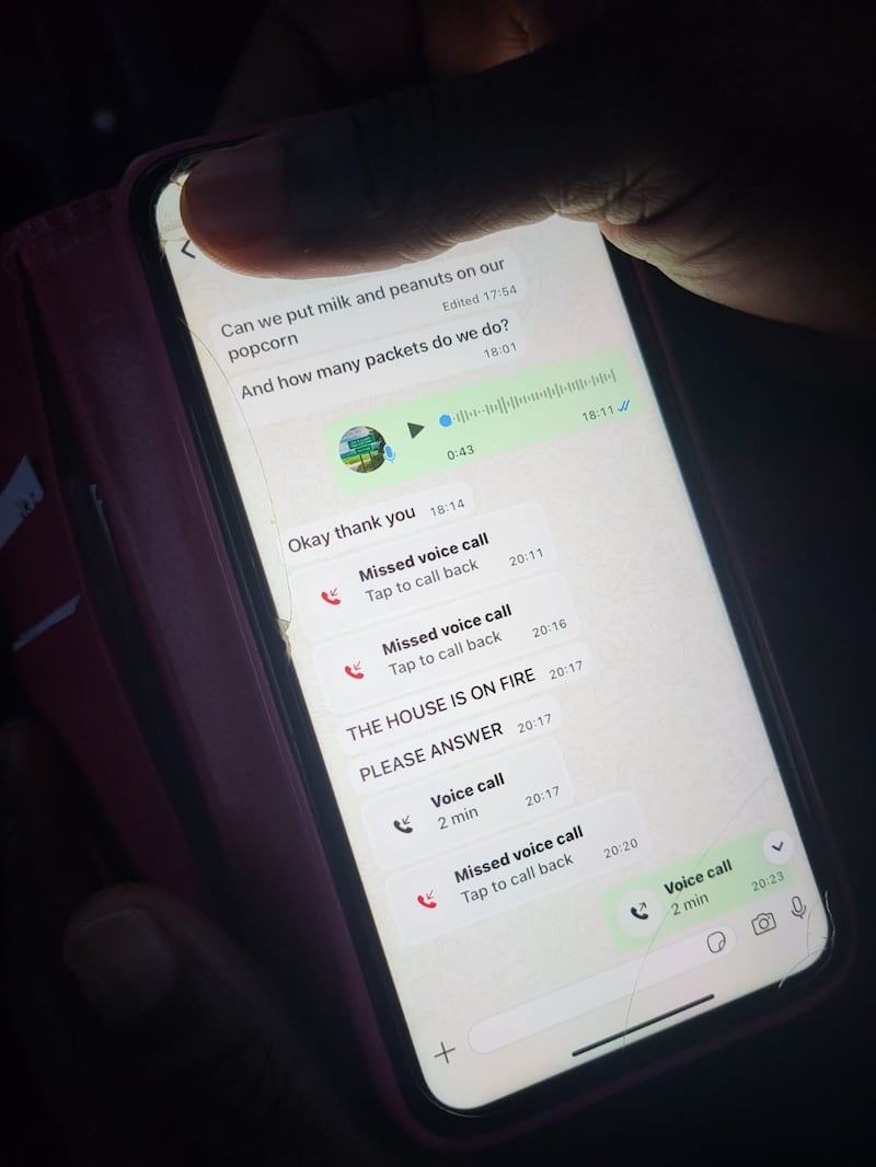 A mother holds her phone showing messages received from one of her children who was in the centre when the fire started. Photograph: Kitty Holland
