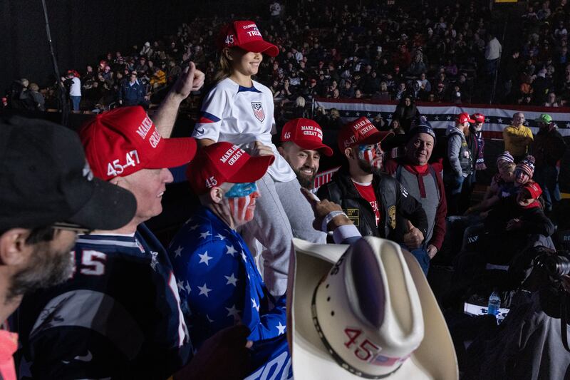 Supporters of former US president Donald Trump take a group picture while waiting for the start of a Trump campaign rally at SNHU Arena in Manchester, New Hampshire. Photograph: Michael Reynolds