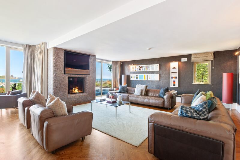 Living room with floor-to-ceiling windows overlooking harbour