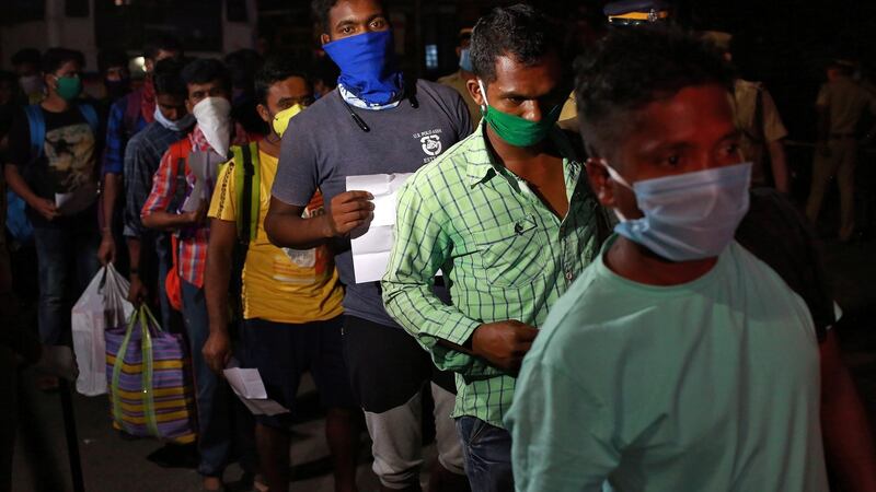 Migrant workers, who were stranded in the southern state of Kerala due to the lockdown imposed by the government, arrive at a railway station to leave for their home state of eastern Odisha, in Kochi, India. Photograph: Reuters/Sivaram V