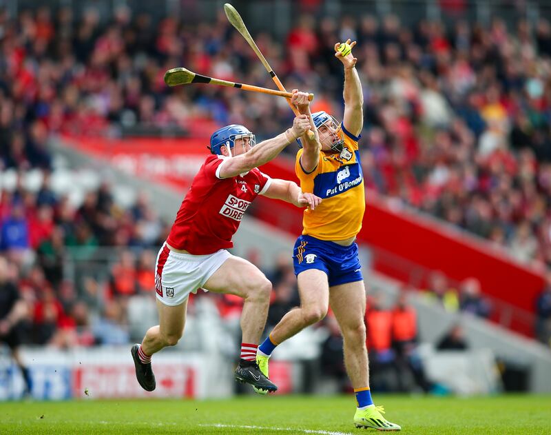 Clare’s Shane O’Donnell catches the ball ahead of Cork’s Sean O’Donoghue. Photograph: Ken Sutton/Inpho