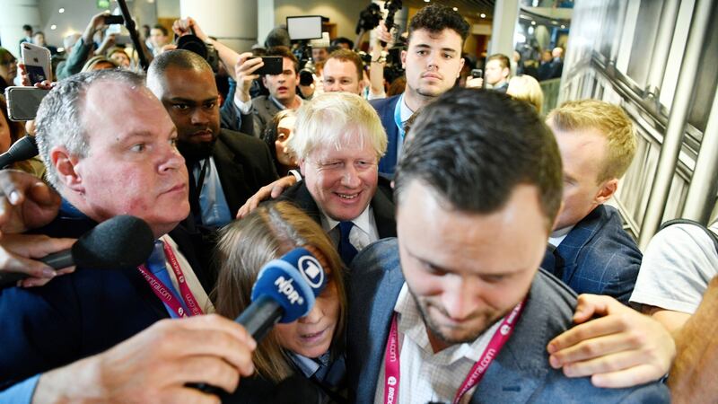 Former foreign secretary Boris Johnson (C) arrives to speak at a fringe event at the conference centre in Birmingham. Photograph: EPA/NEIL HALL