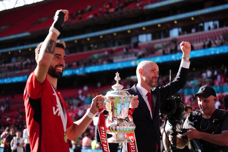 Manchester United's Bruno Fernandes and manager Erik ten Hag with the FA Cup Trophy after winning the Emirates FA Cup final at Wembley Stadium. Photograph: John Walton/PA Wire