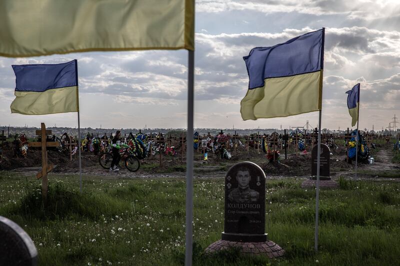 Ukrainian flags fly at the Krasnopil's'ke military cemetery, where there are more than 400 new graves, in Dnipro, Ukraine. Photograph: Finbarr O’Reilly/New York Times