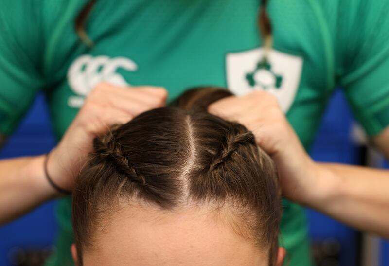 Kayla Waldron braids Leah Tarpey's hair in the changing rooms.
Photograph: Laura Hutton