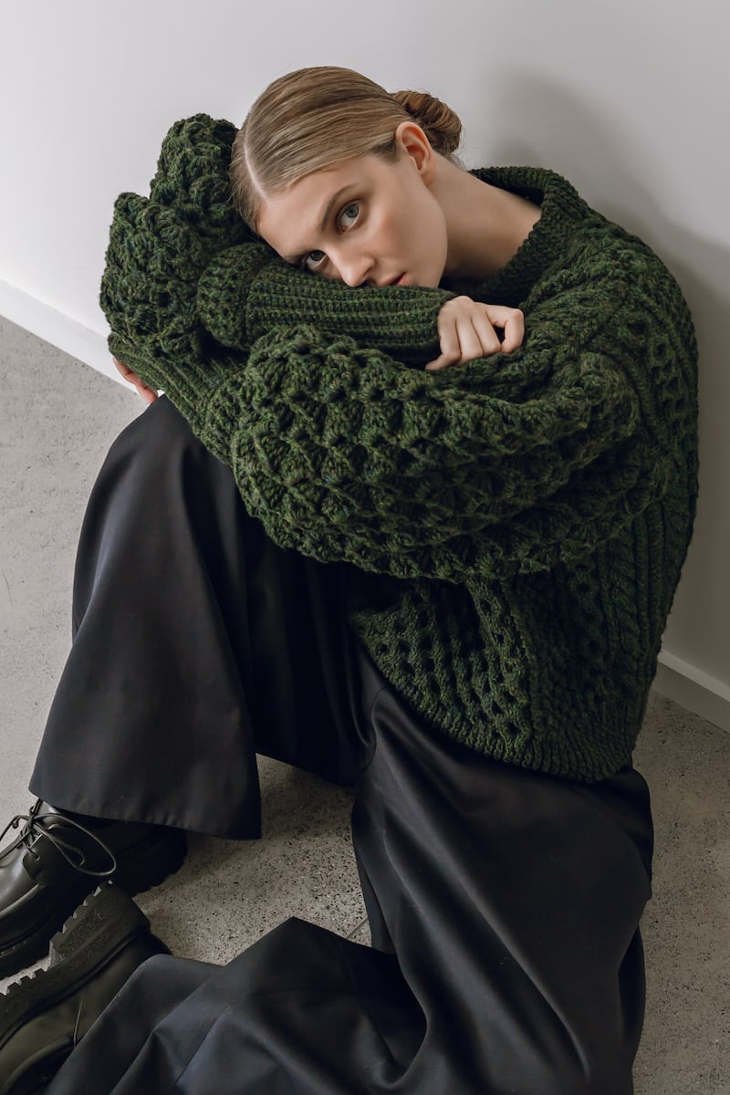 Colin Burke handknit Aran sweater with puff sleeves in forest green wool €1450, navy wide leg trousers €775 Simone Rocha at Havana boutique. Photographer: Tetyana Maryshko