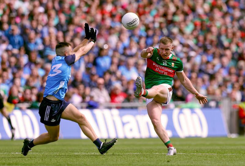 Mayo's Ryan O'Donoghue kicks past Paddy Small of Dublin. Photograph: John McVitty/Inpho
