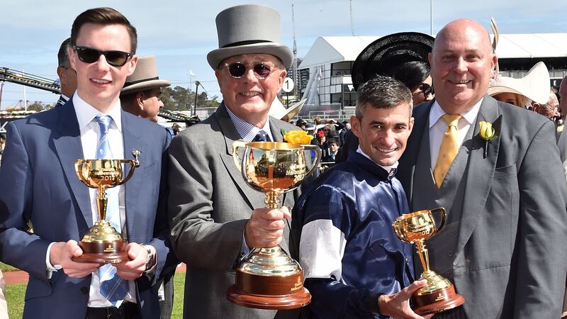 Lloyd Williams lead owner, trainer Joseph O’Brien, jockey Corey Brown and Emirates’ Barry Brown hold their trophies after their horse Rekindling won the 157th Melbourne Cup at Flemington Racecourse in Melbourne. Photograph: Getty Images