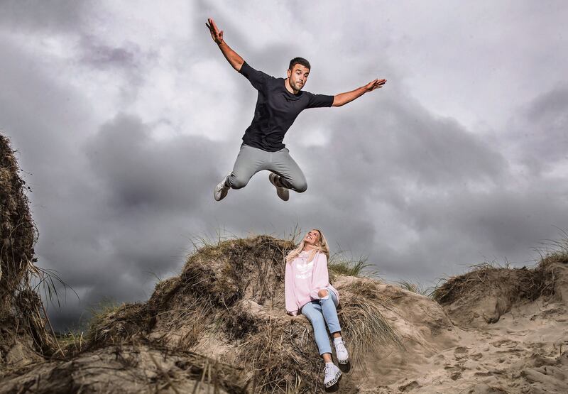 Ireland Rugby World Cup Portraits 2019 Conor Murray with his girlfriend Joanna jumping off a sanddune in Derrynane in Co Kerry. Murray is from Patrick's Well and it means a lot to him. Mandatory Credit ©INPHO/Dan Sheridan