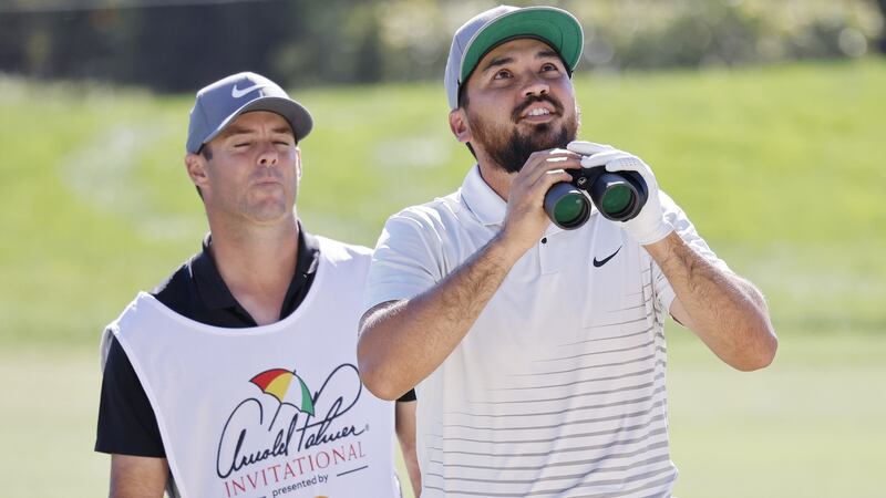 Jason Day uses a pair of binoculars to find his ball stuck in a tree on the 16th hole during the second round of the Arnold Palmer Invitational. Photograph: EPA