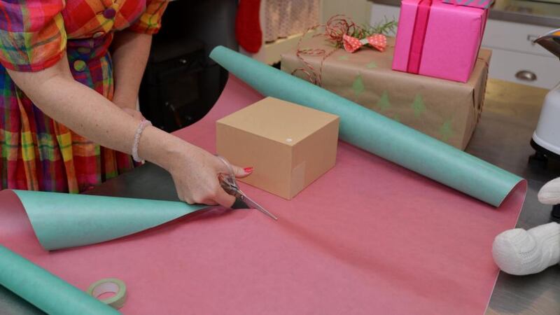 Step 1: Put the gift down on your wrapping paper and measure it. You don’t need a big overlap – I’m leaving just enough at the ends to cover the present. Photograph: Alan Betson