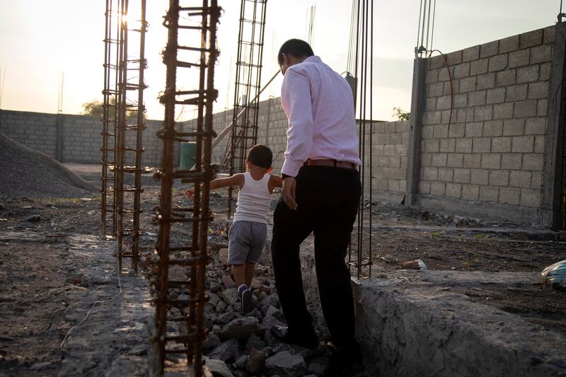 The sicario with his son after a visit to a church, before returning to the witness protection programme in a prison where he stays for his own safety, in Mexico.  Photograph: Alexandra Garcia/The New York Times