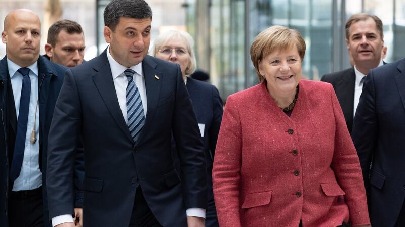 Prime minister of Ukraine Volodymyr Groysman, (left) and German Chancellor Angela Merkel arrive for the third German-Ukrainian business forum in Berlin, Germany on  November 29th Photograph: Hayoung Jeon/EPA