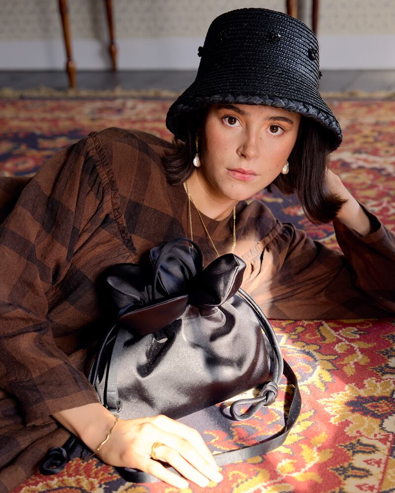 Black straw hat, FAO Millinery; dress, €390, Jennifer Slattery; black bag, €275, August Night; and jewellery, Inner Island