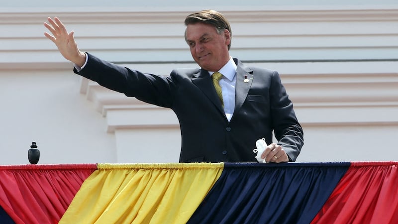 Brazil’s president Jair Bolsonaro greets the crowd from a balcony of Carondelet Palace in Quito after attending the inauguration of Ecuador’s new president Guillermo Lasso at the National Assembly, on May 24th. Photograph: Cristina Vega Rhor/AFP via Getty