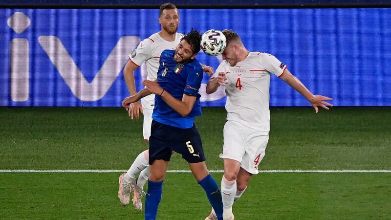 Italy’s  Manuel Locatelli  and Switzerland’s  Nico Elvedi vie for the ball during the game in Rome. Photograph: Riccardo Antimiani/AFP via Getty Images