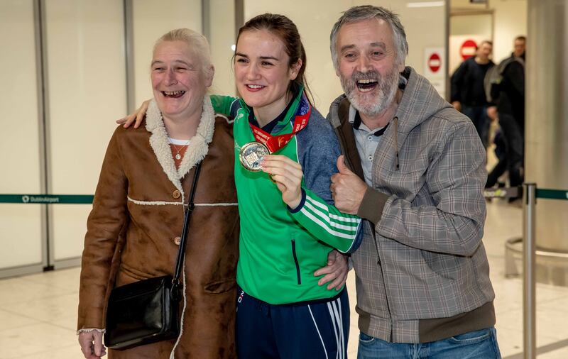 Kellie Harrington with her parents Yvonne and Christy at Dublin airport after winning gold at the AIBA Women's World Boxing Championships Lightweight Final. Photograph: Morgan Treacy/Inpho