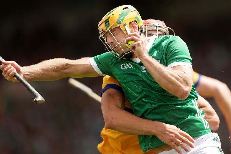 Limerick's Dan Morrissey is tackled by Peter Duggan of Clare. Morrissey has proved a dependable and versatile rock in the Limerick defence. Photograph: Laszlo Geczo/Inpho 