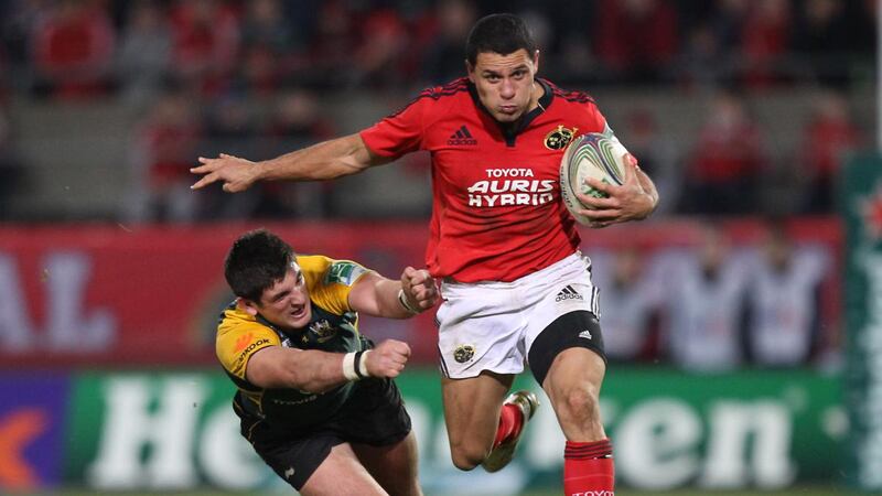 Munster’s Doug Howlett  runs past Calum Clark of Northampton. Photograph: Billy Stickland/Inpho