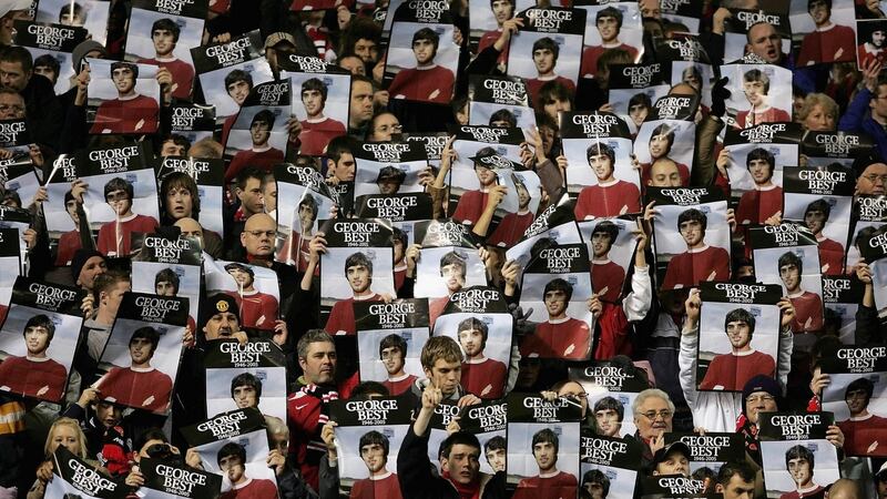 Manchester United fans hold up posters of Best at Old Trafford after his death in 2005. Photo: Getty Images