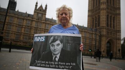 Campaigner June Hautot holds a photo of Aneurin “Nye” Bevan, who spearheaded the establishment of the National Health Service (NHS).Photograph: Peter Macdiarmid/Getty Images