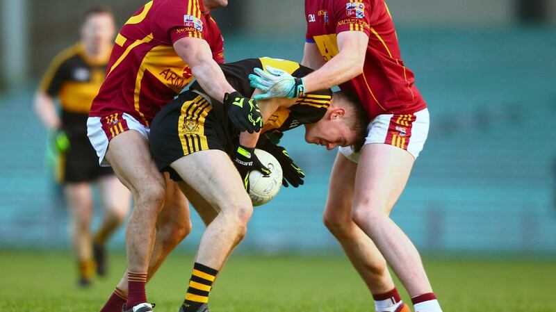Dr Crokes’ Daithí Casey is tackled by Miltown-Malbay’s Graham Kelly and Darragh McDonagh. Photograph: Ken Sutton/Inpho