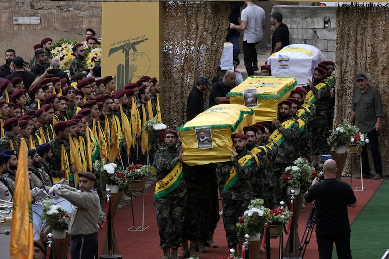 Hizbullah fighters carry the coffins of four comrades who were killed on Tuesday after their handheld pagers exploded. Photograph: Bilal Hussein/AP