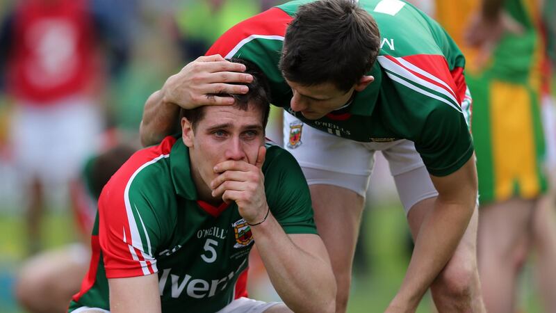 Lee Keegan of Mayo is consoled by Jason Doherty following defeat to Donegal in the 2012 All-Ireland final at Croke Park. Photograph: Donall Farmer/Inpho