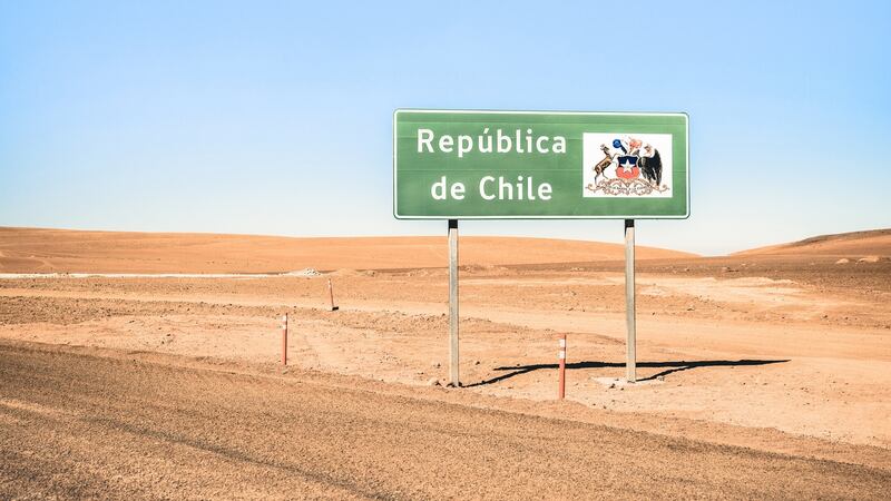 Border sign on desert crossing road on way to Bolivia through Atacama desert mountains. Photograph: ViewApart
