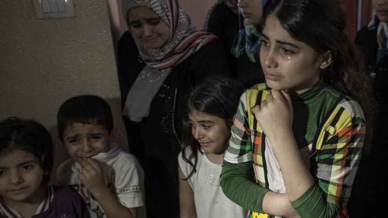Relatives during the funeral of one-and-a-half year old Razel Netzlream in Khan Younis, central Gaza Strip. Photograph:  EPA
