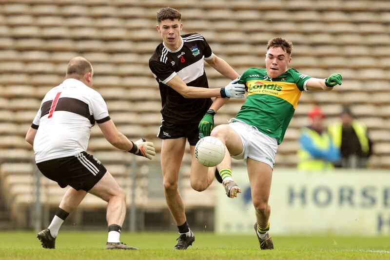 Clonmel Commercials' Peter McGarry with Emmet Rigter and goalkeeper Michael Quilligan of Newcastle West. Photograph: Laszlo Geczo/Inpho
