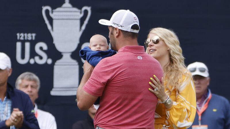 Rahm with his son Kepa and wife Kelley after leaving the 18th green. Photo: Erik S. Lesser/EPA