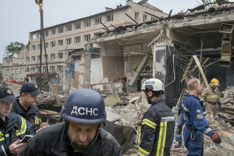 Rescue workers and firefighters at the site of Tuesday’s Russian missile strike on a popular restaurant in Kramatorsk, Ukraine, on Wednesday, June 28th, 2023. Photograph: Mauricio Lima/New York Times
                      