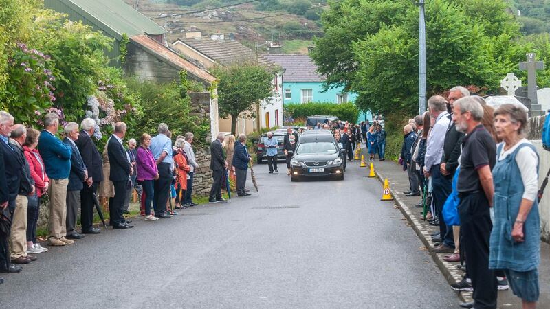 People lined the streets of Goleen, Co Cork,  as PJ Sheehan’s funeral cortege makes its way to the church. Photograph: Andy Gibson.