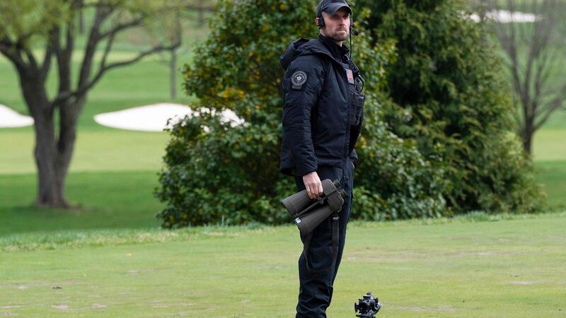 A US Secret Service sniper watches the course as Biden plays. Photo: Jim watson/AFP via Getty Images
