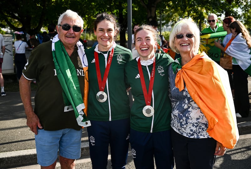 Katie-George Dunlevy of Ireland, second from left, with pilot Linda Kelly and parents John and Alana after winning silver in the women's B road race on Friday at the Paris 2024 Paralympic Games at Clichy-sous-bois in Paris, France. Photograph: Harry Murphy/Sportsfile