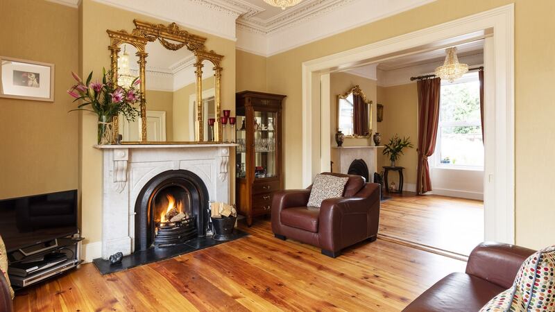 Both windows in the dining and sitting rooms are sash, and feature Victorian shutters