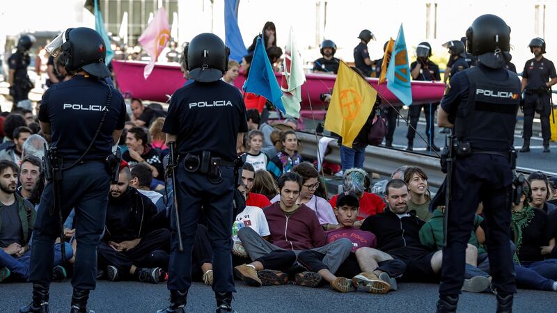 Activists block the traffic in a flyover in downtown Madrid, Spain. Photo: EPA/Emilio Naranjo