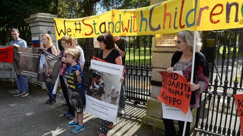 Activists held up a banner proclaiming “We #Stand with Children of Syria” outside the Russian embassy in Dublin today. Photograph: Eric Luke/The Irish Times