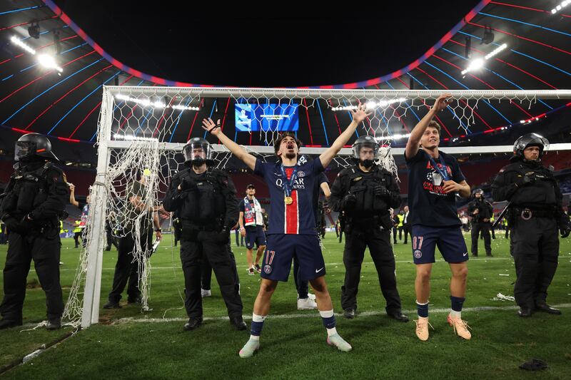 Paris Saint-Germain's Vitinha and Joao Neves celebrate in front of supporters on Saturday night in Munich. Photograph: Franck Fife/Getty