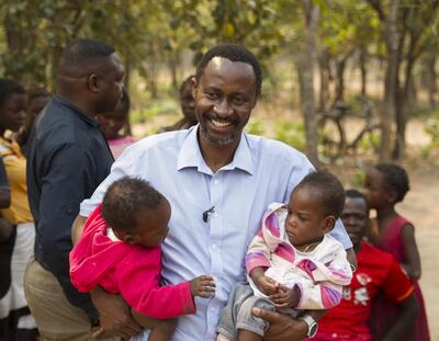 Dr Bruce Bvulani, head of paediatric surgery at University Teaching Hospital, Lusaka, holding Bupe and Mapalo Mwape in Chabatama, northern Zambia in September, 2018.