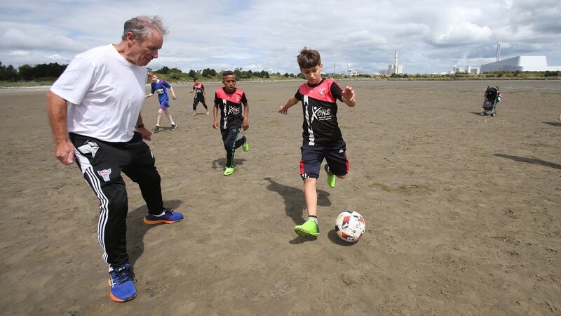 Brian Kerr with members of the Al-Helal football academy during a training session on Dublin’s Sandymount Strand. Photograph: Niall Carson/PA