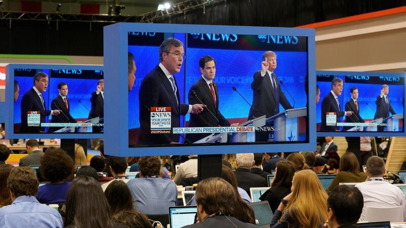 Screens showing republican US presidential candidate businessman Donald Trump (right) and former governor Jeb Bush (left) debate as US senator Marco Rubio (centre) stands between the two men. Photograph: Reuters