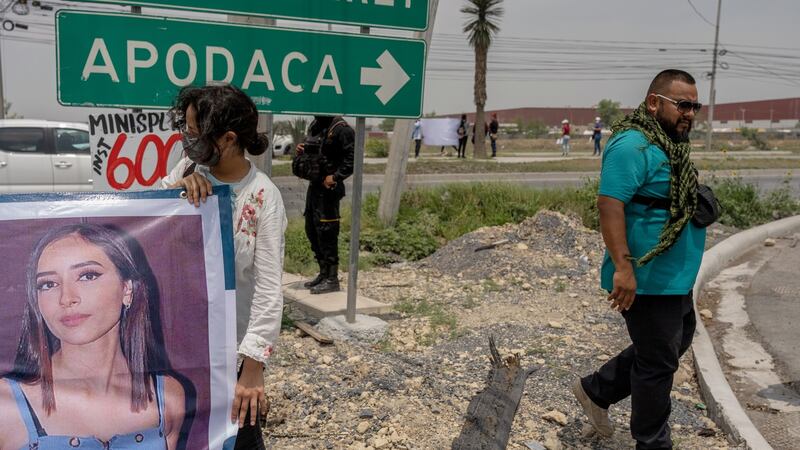 Volunteers by a road in Monterrey, Mexico, hold up a sign on April 21st with information about Debanhi Escobar, a missing young woman whose body was found later that night. Photograph: Alejandro Cegarra/New York Times
