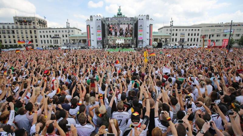 Fans cheer and celebrate as they wait for the arrival of the Germany’s national soccer squad at the welcome reception in front of the Brandenburg Gate in Berlin. Photograph: Michael Kappeler/EPA