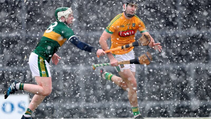 Kerry’s Daniel Collins and Shane Whitty of Meath battle for the ball in the snow. Photo: James Crombie/Inpho