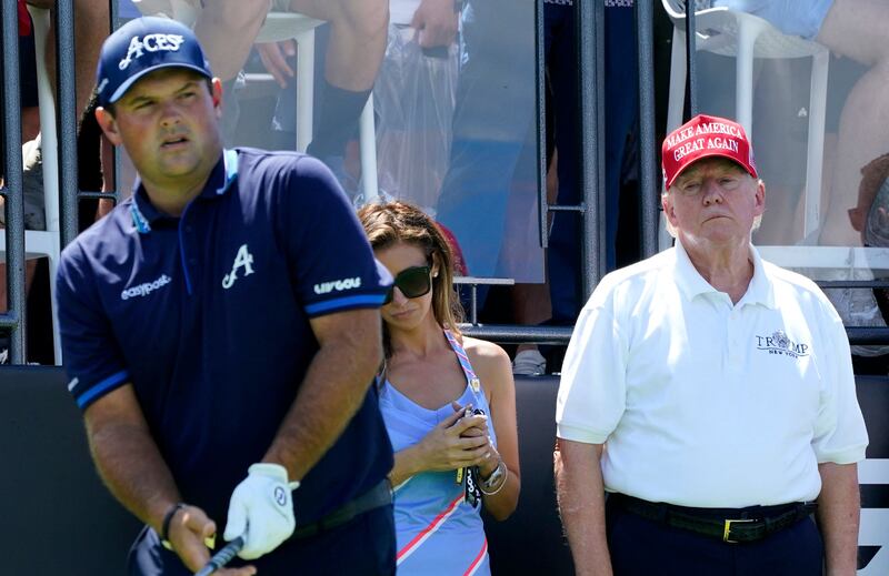 Reed between the lies: Donald Trump watches professional golfer Patrick Reed's attempt to shoot under 67 at Bedminster. Photograph: Getty Images