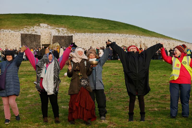 Visitors to Newgrange form a large circle chanting and enjoying the moments of sunrise. Photograph: Alan Betson
