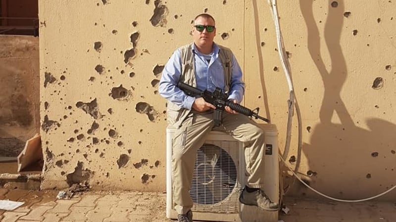 Mark McManus providing protection for  a VIP visiting  the former ISIS headquarters in Fallujah, which now serves as a